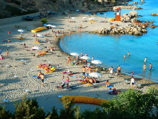 Turquoise water and rocky shore at Konnos Bay