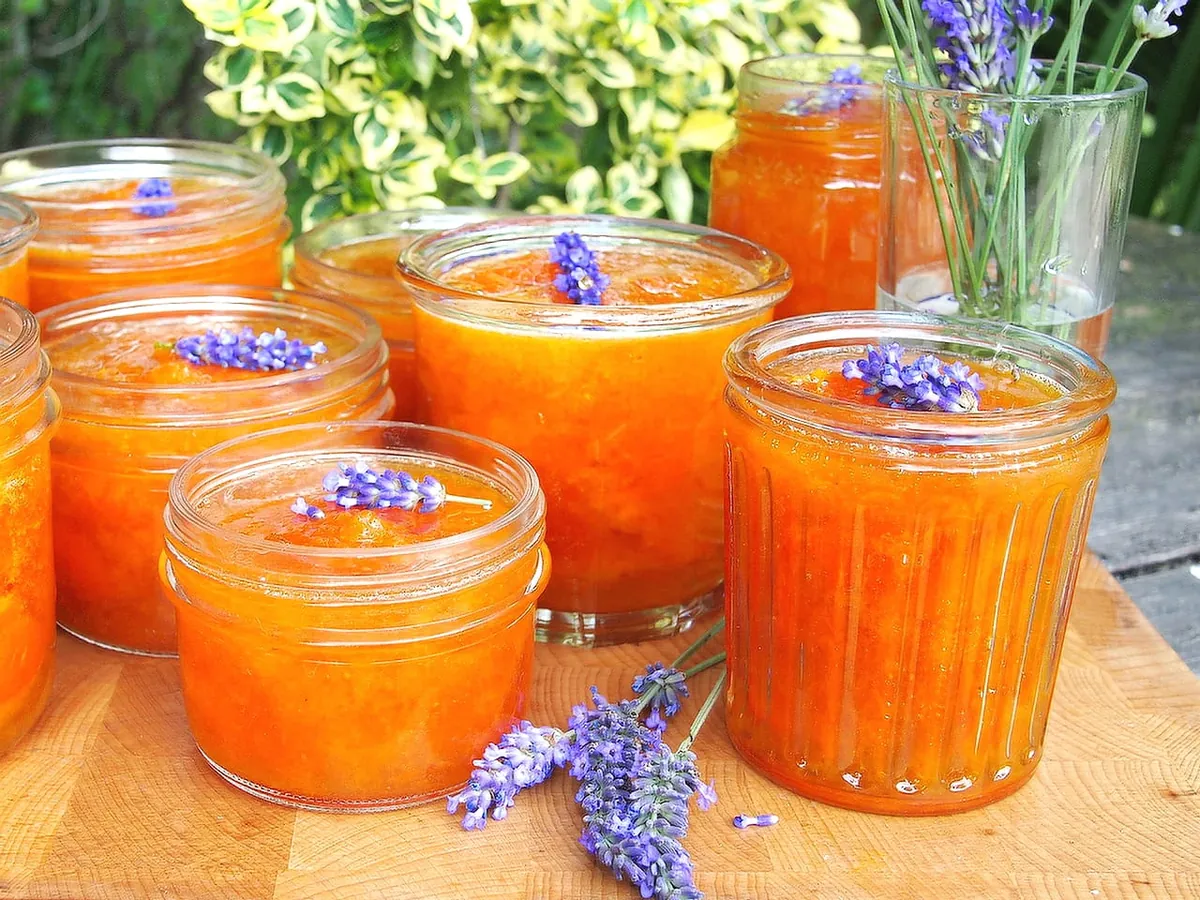 Jars of homemade apricot jam decorated with lavender