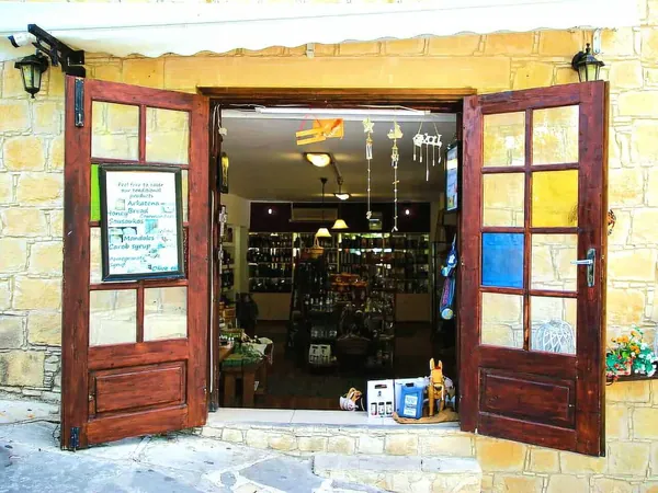 Open wooden doors of a village shop in Omodos