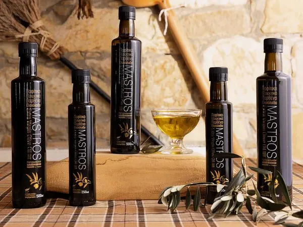 Bottles of Mastros olive oil on a wooden table