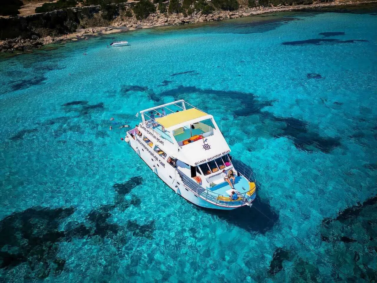 Boat at anchor over the clear water of the Blue Lagoon
