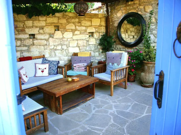 Shaded stone courtyard with seating in Lania