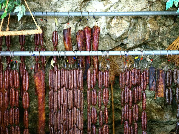 Lountza and sausages hanging in a village smokehouse