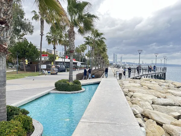 Palm-lined Molos seafront promenade with a water channel in Limassol