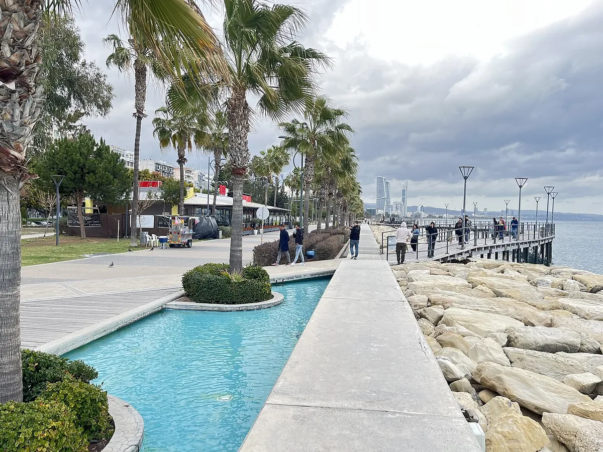 Palm-lined Molos seafront promenade with a water channel in Limassol