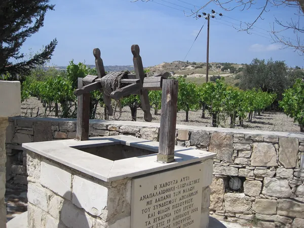 Old stone wine press and well in a Pissouri courtyard